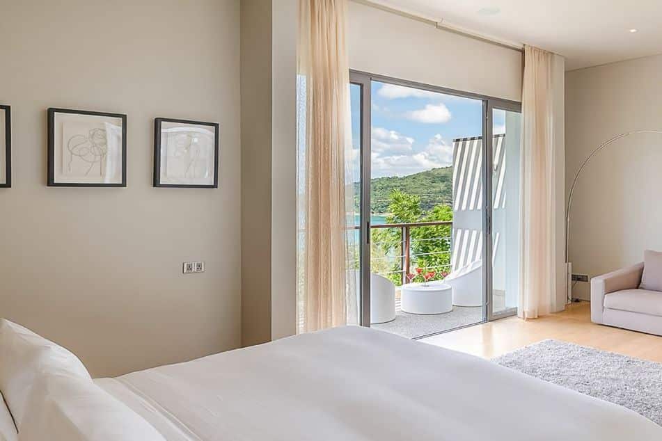 A light coloured peaceful bedroom with sea views.