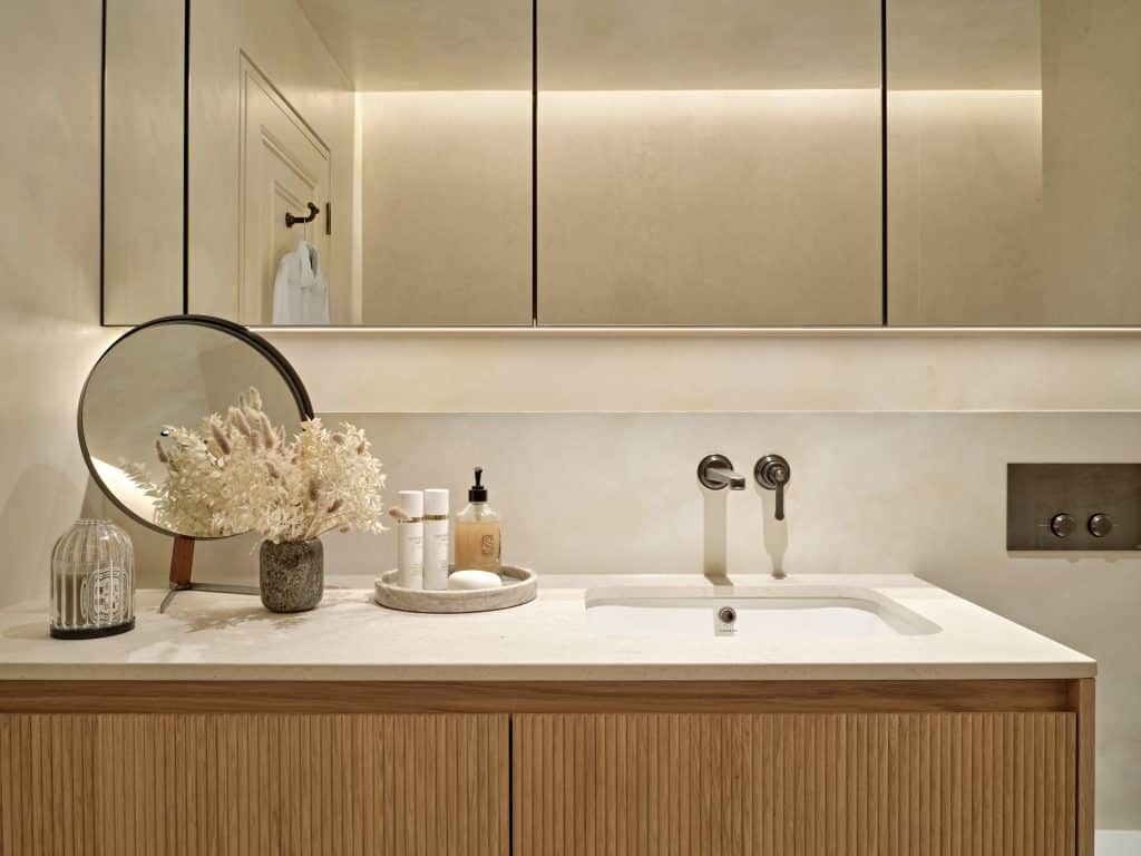 Countertop and cabinetry in neutral relaxing bathroom.