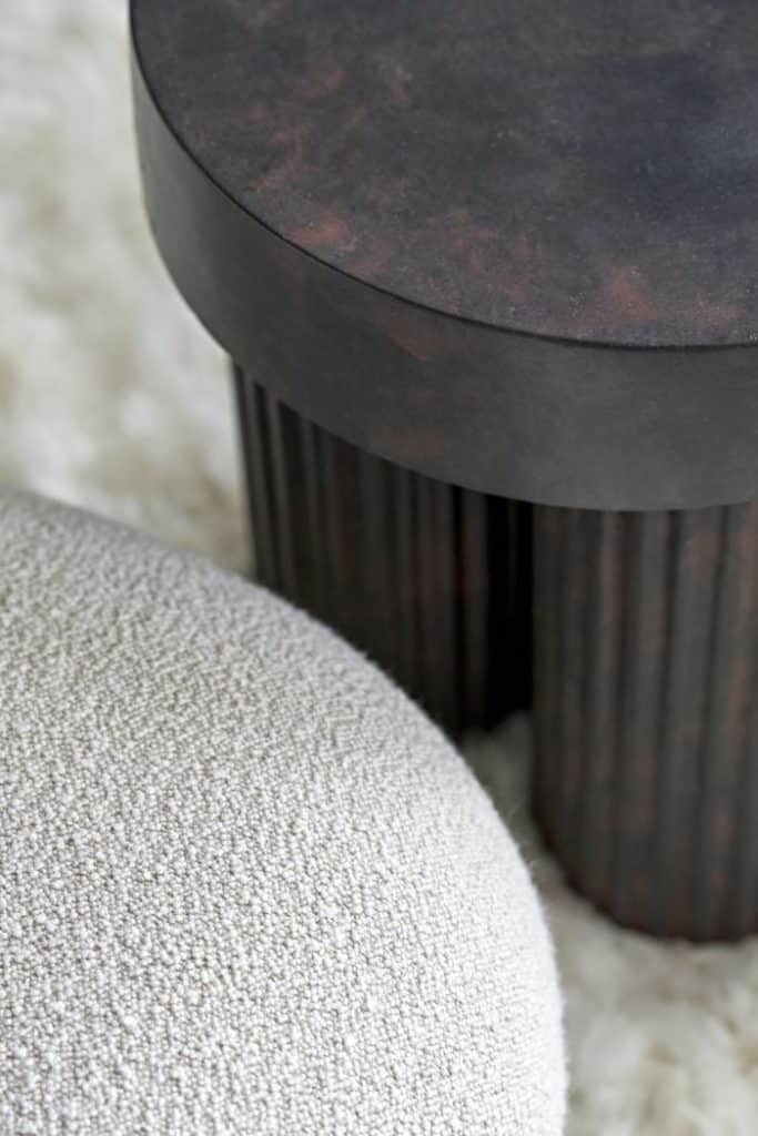Close up of textures in a drawing room. Fluffy rug, boucle fabric and armchair.