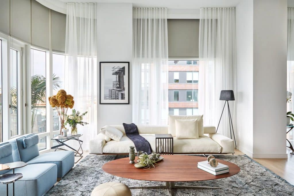 A sophisticated new york penthouse featuring silk rugs and seating from flexform.