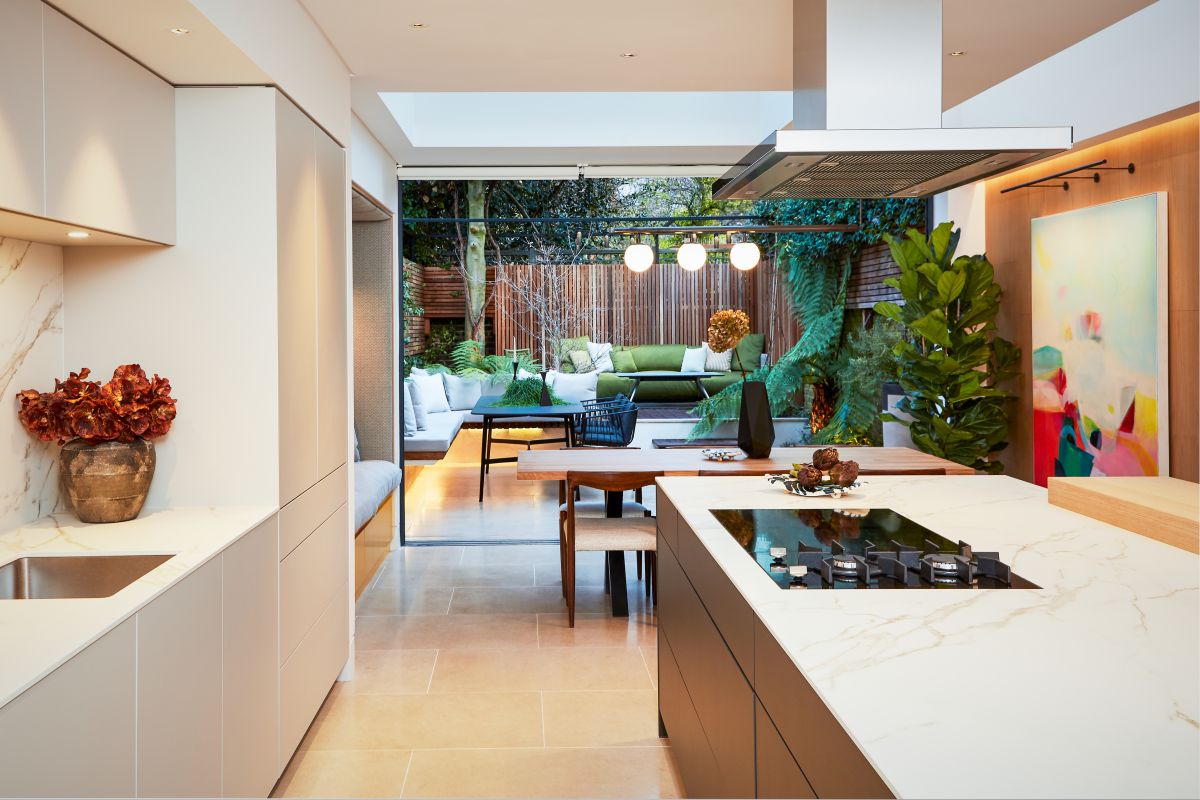 A large open plan kitchen and dining room leads to an outdoor terrace. 