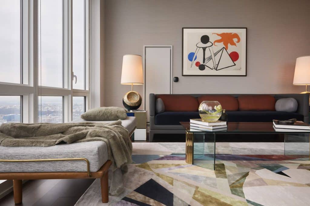 A silk rug grounds this living room with jewel tones to compliment the Alexander Calder art hanging above the sofa.