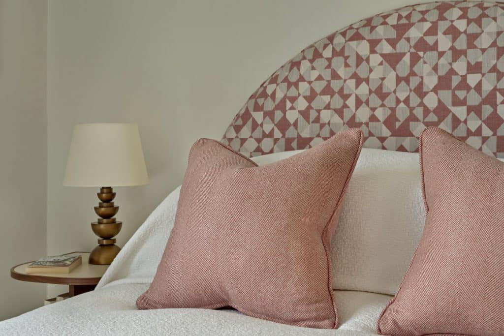 Circle headboard with pink patterned fabric from Holland and Sherry Fabrics.