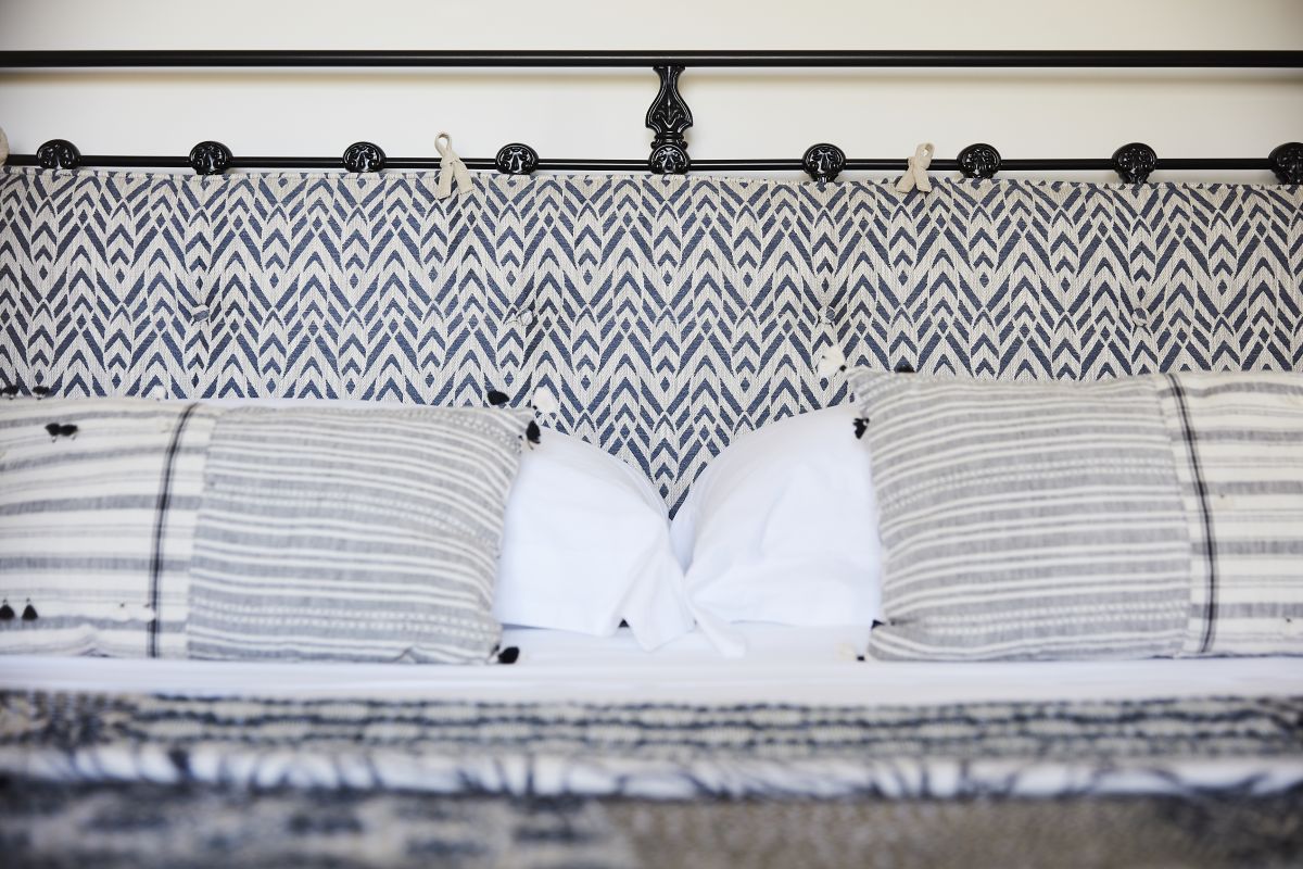 Sea side holiday home bedroom with blue and white textiles.