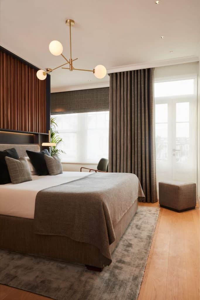 Mark Alexander fabrics in bedroom with walnut headboard and furl max ottoman bedbase.
