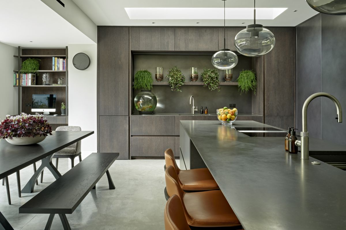 Open space kitchen and dining room with dark furniture and cabinets.