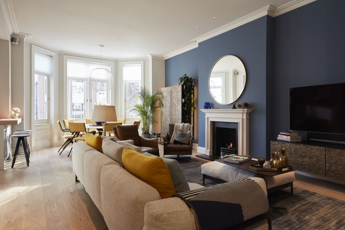 Flexform Zeno Light sofa in large open plan living room with blue walls. 