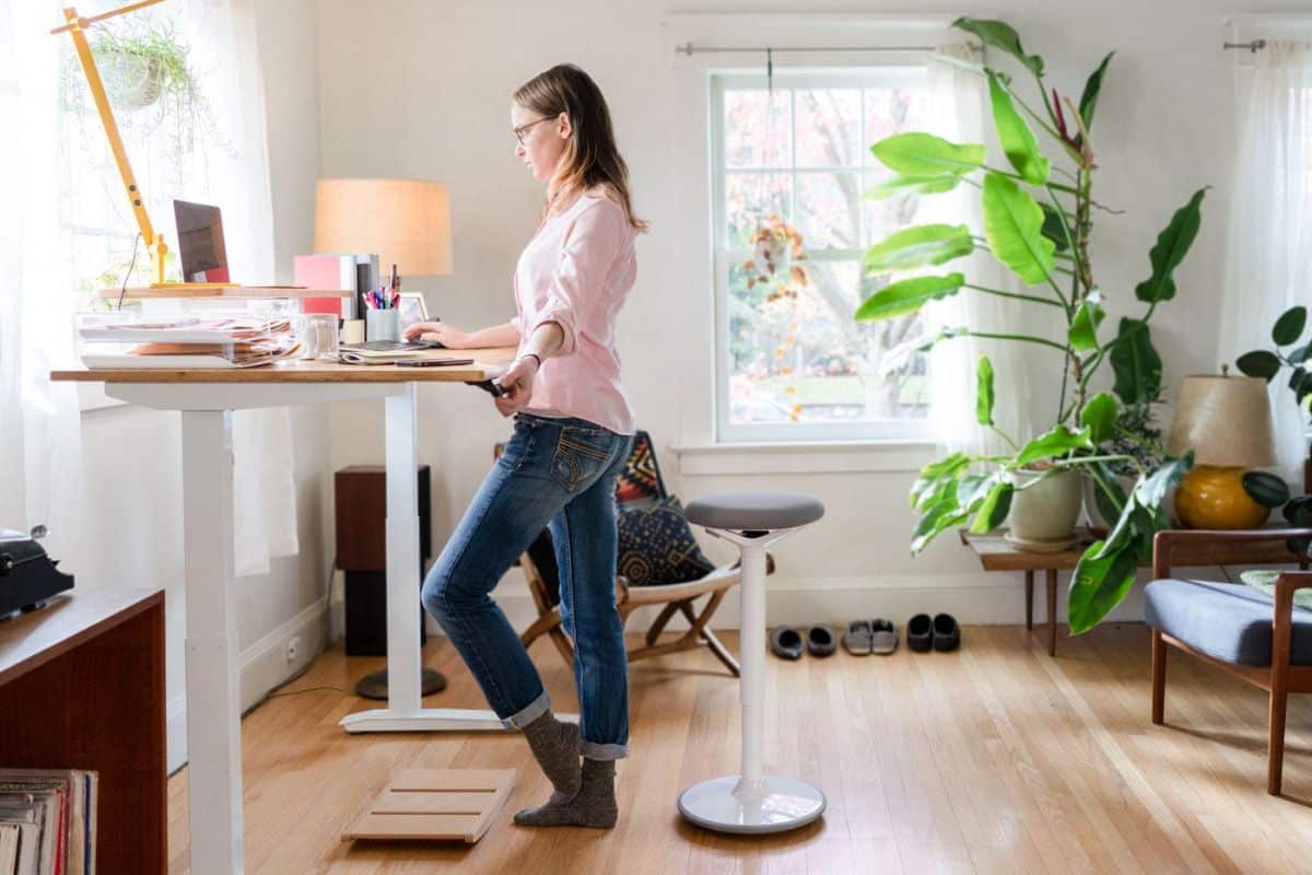 Woman at a standing desk in her home office