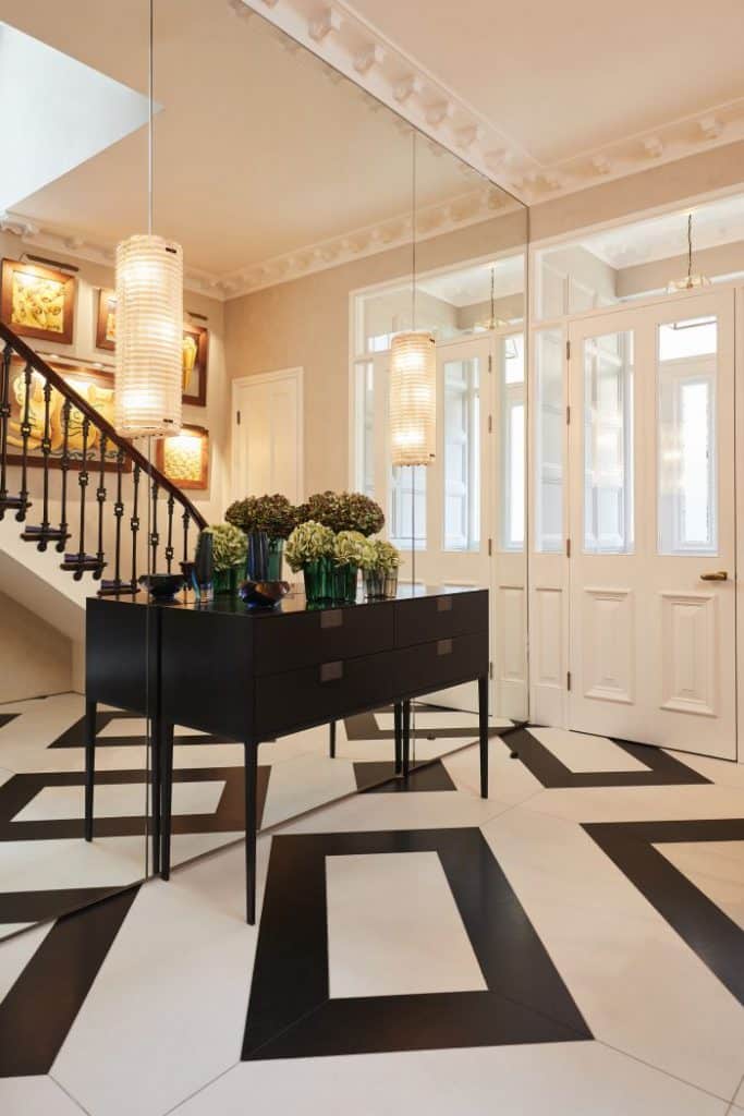 Period london property entrance with mirrored wall and marble floors.