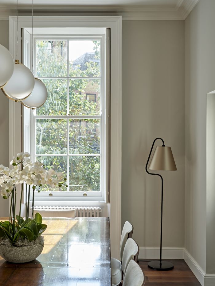 Floor lamp with champagne coloured shade in dining room.