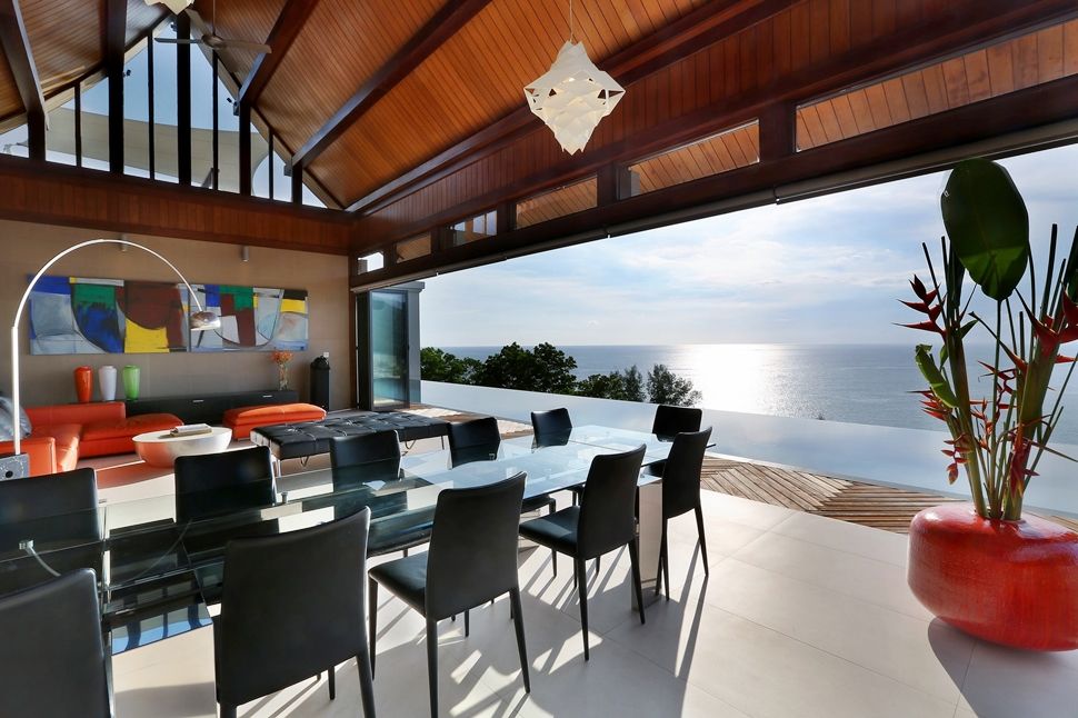 Indoor outdoor living area leading to an infinity pool with sea views.