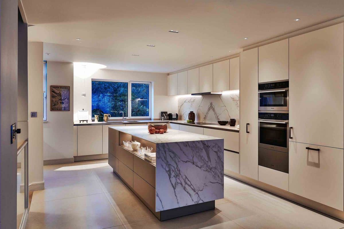 Luxury open-plan kitchen lit with LED linear strip under counters and island