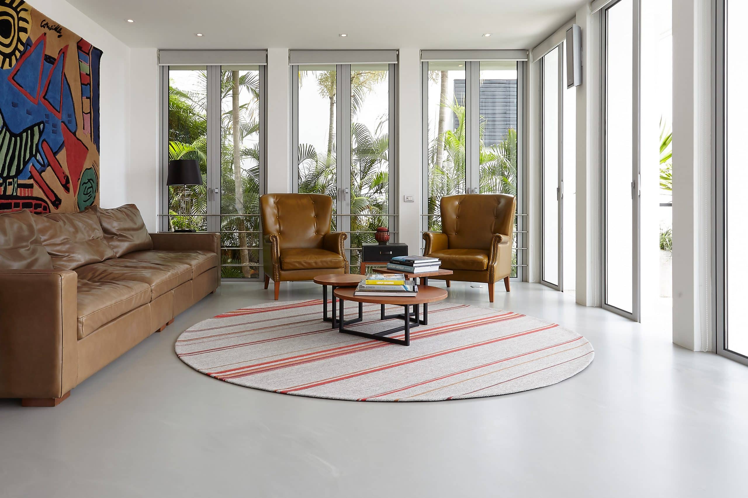 Living space of a coastal style villa. A limited edition belgian rug is located in the center.