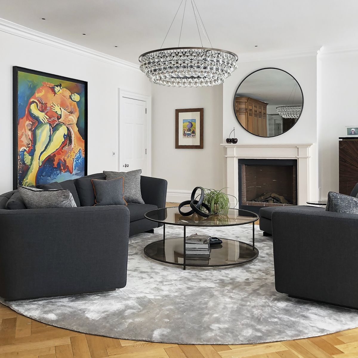 A pair of minotti curved Jacques sofas create a conversation friendly area in this family living room. 
