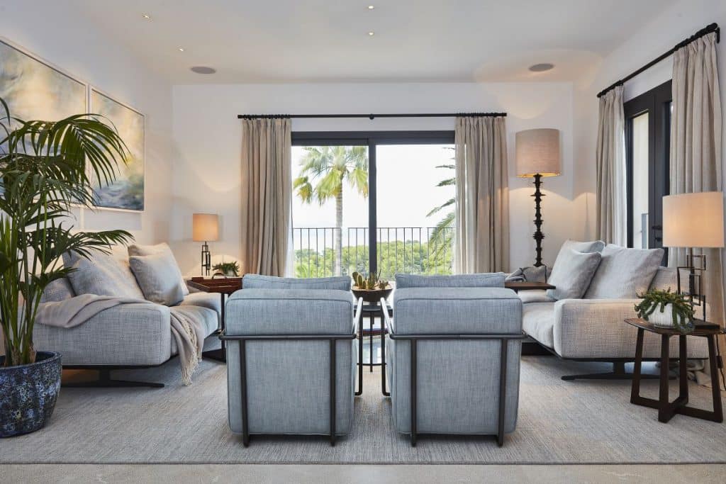 A modern mallorcan villa living room interior with natural stone and sea views.
