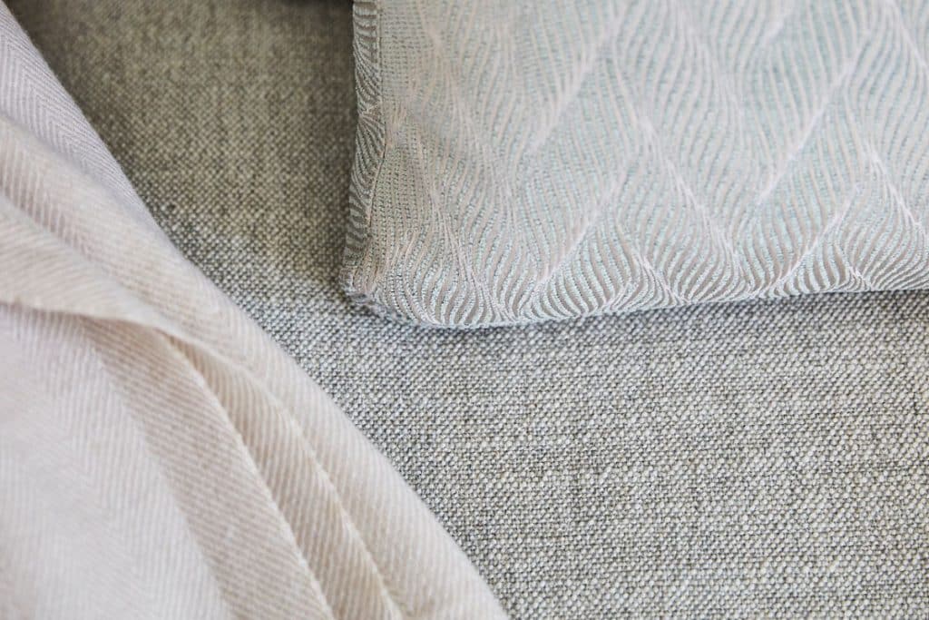 Neutral beige and light blue soft furnishing details.