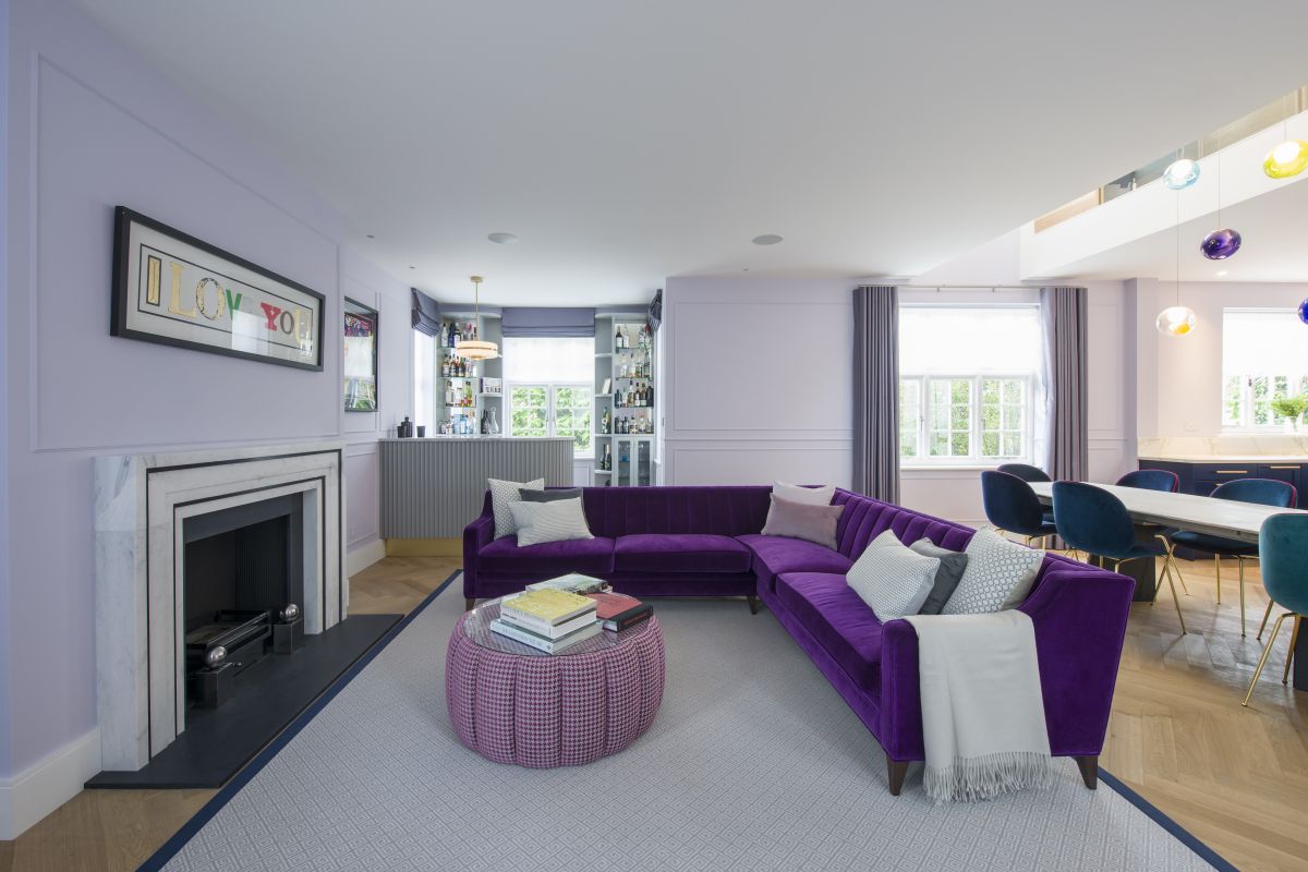 Bar and games room lounge area with purple sofas.