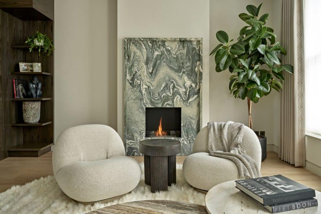 Statement green marble fireplace being in the center of focus in livingroom.