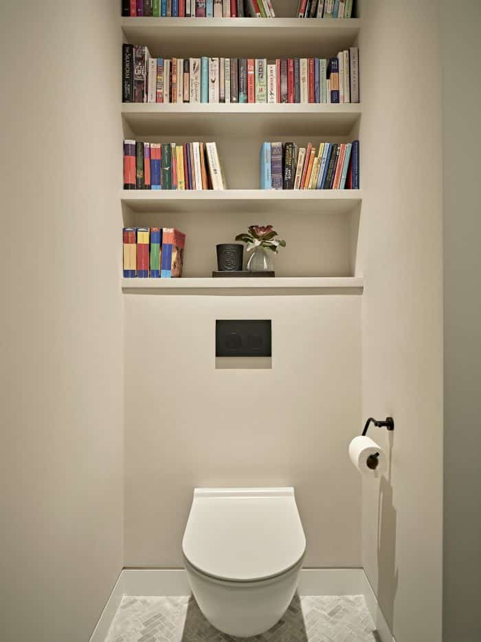 Simple WC with library shelves above toilet