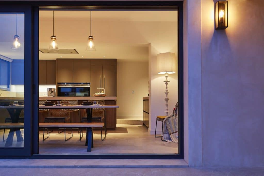 Large sliding doors open the kitchen up to the outdoor terrace beyond.