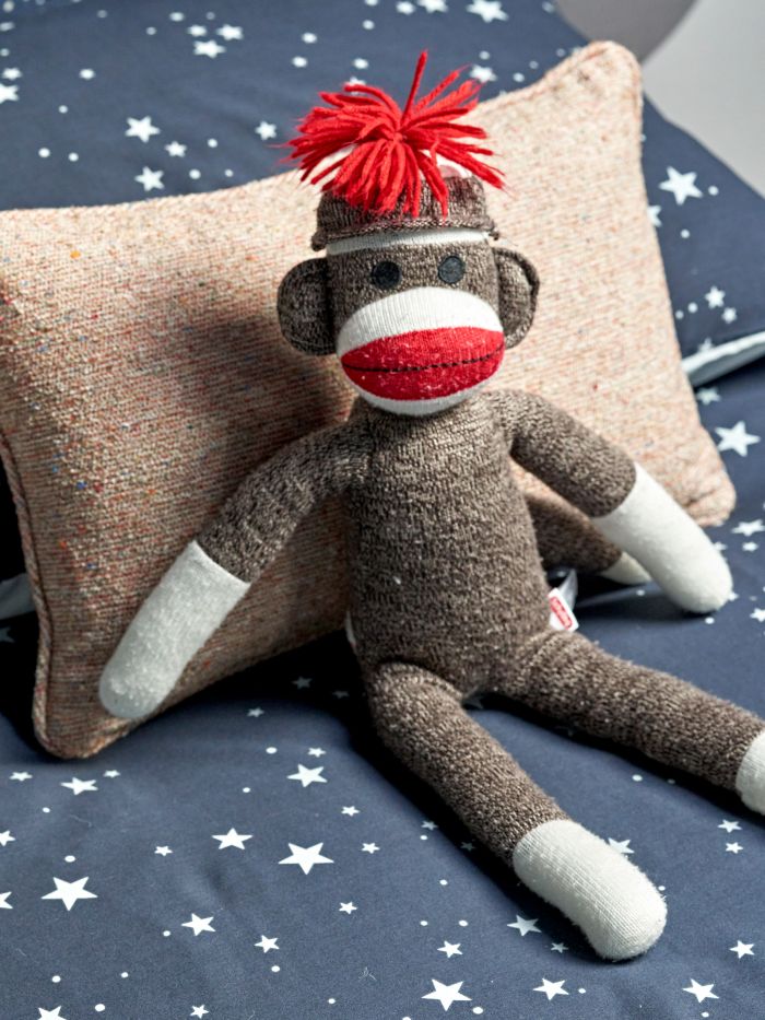 zinc pougy cocktail bonheur cushion paired with a toy monkey
