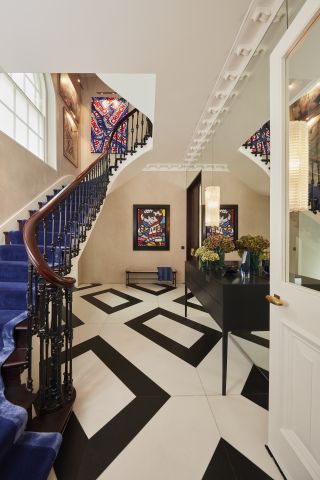 An image of a black and white marble floor entrance in London period property.