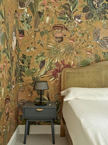 A bold pattern wallpaper from Arte International in a bedroom.