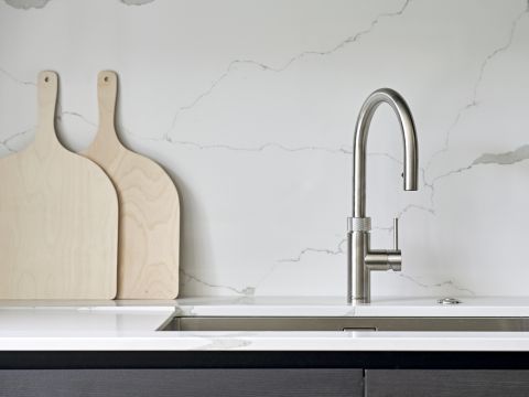 Simple and elegant kitchen with quartz stone top and quooker tap.