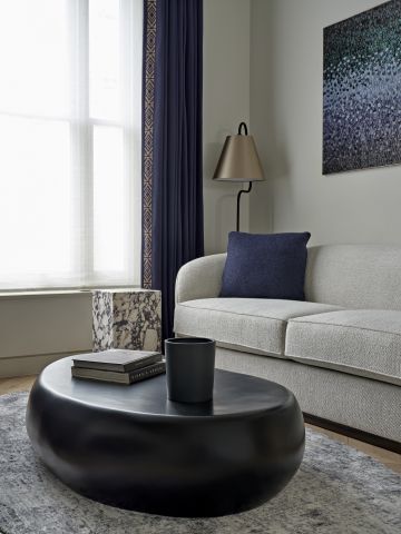 Neutral Anderson Sofa and Navy Blue Aiveen Daly Heat Beads and Feather artwork in living room.