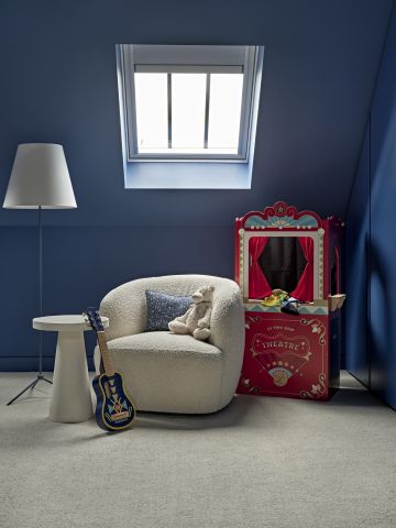 Kids reading area in blue coloured boys bedroom.