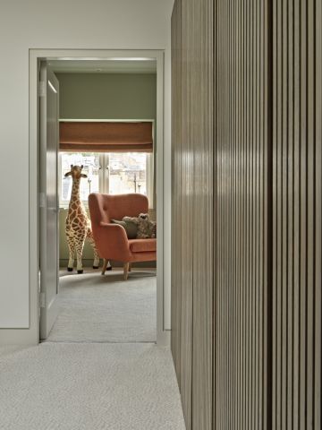 Hallway with utility cabinets in stained wood.