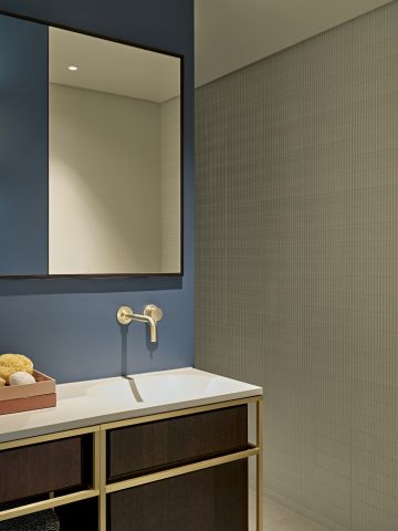 Marca Corona Regoli porcelain stoneware tiles in bathroom which has a pop of colour with a blue wall.