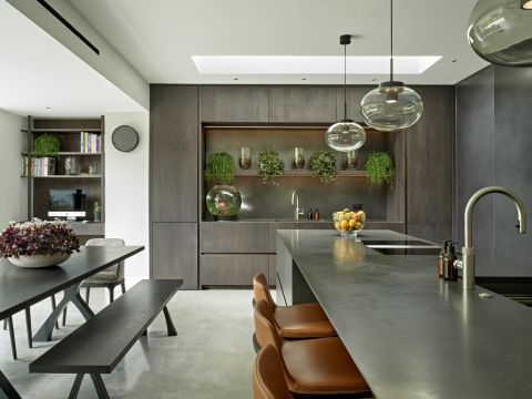 Elegant kitchen with earthy dark tones, decorated with botanicals.
