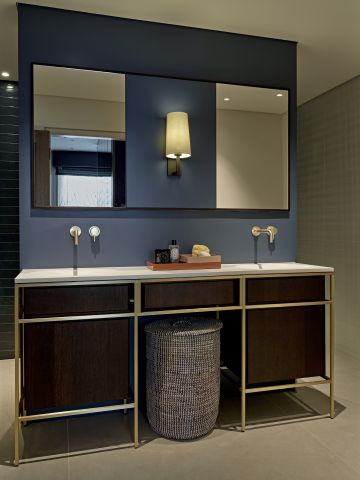 Blue ensuite bathroom for principle bedroom with brass hardware.
