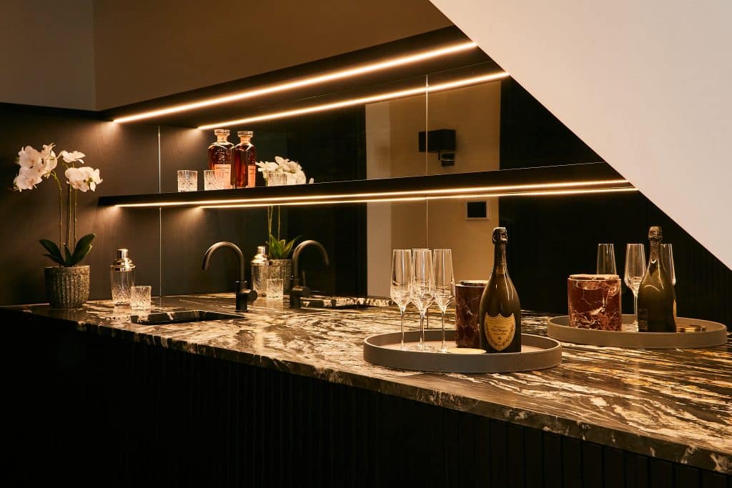 Modern home bar with marble countertop.
