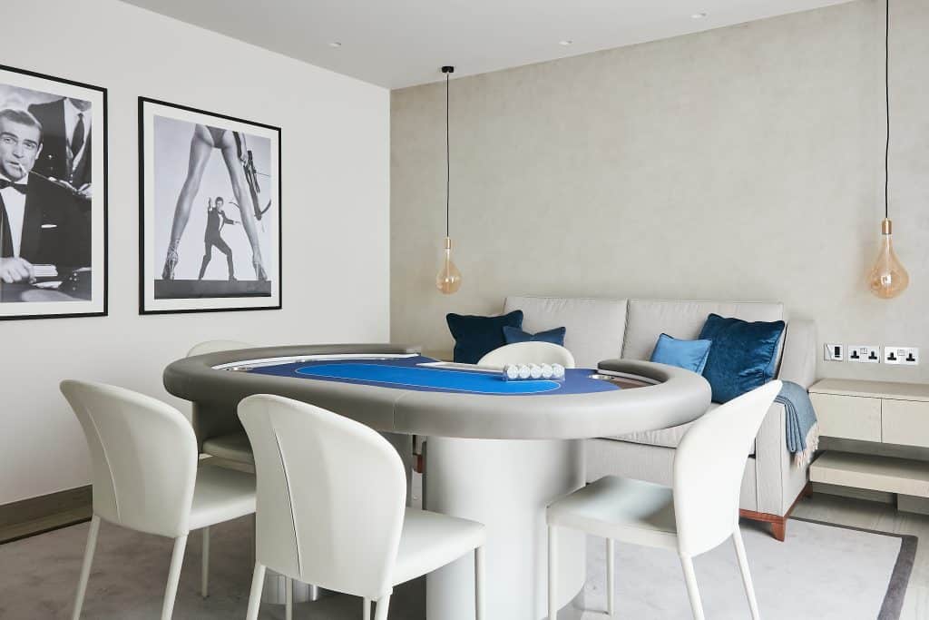 Neutral playroom with poker table in center.