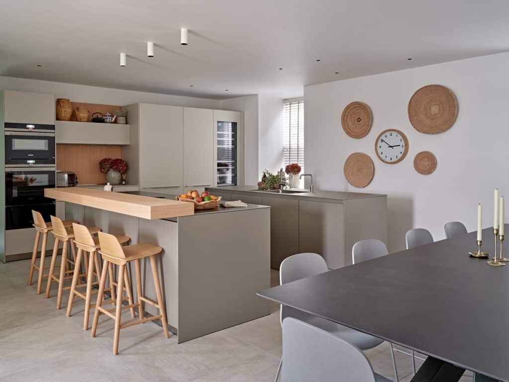 Open plan neutral minimalistic kitchen and dining space.