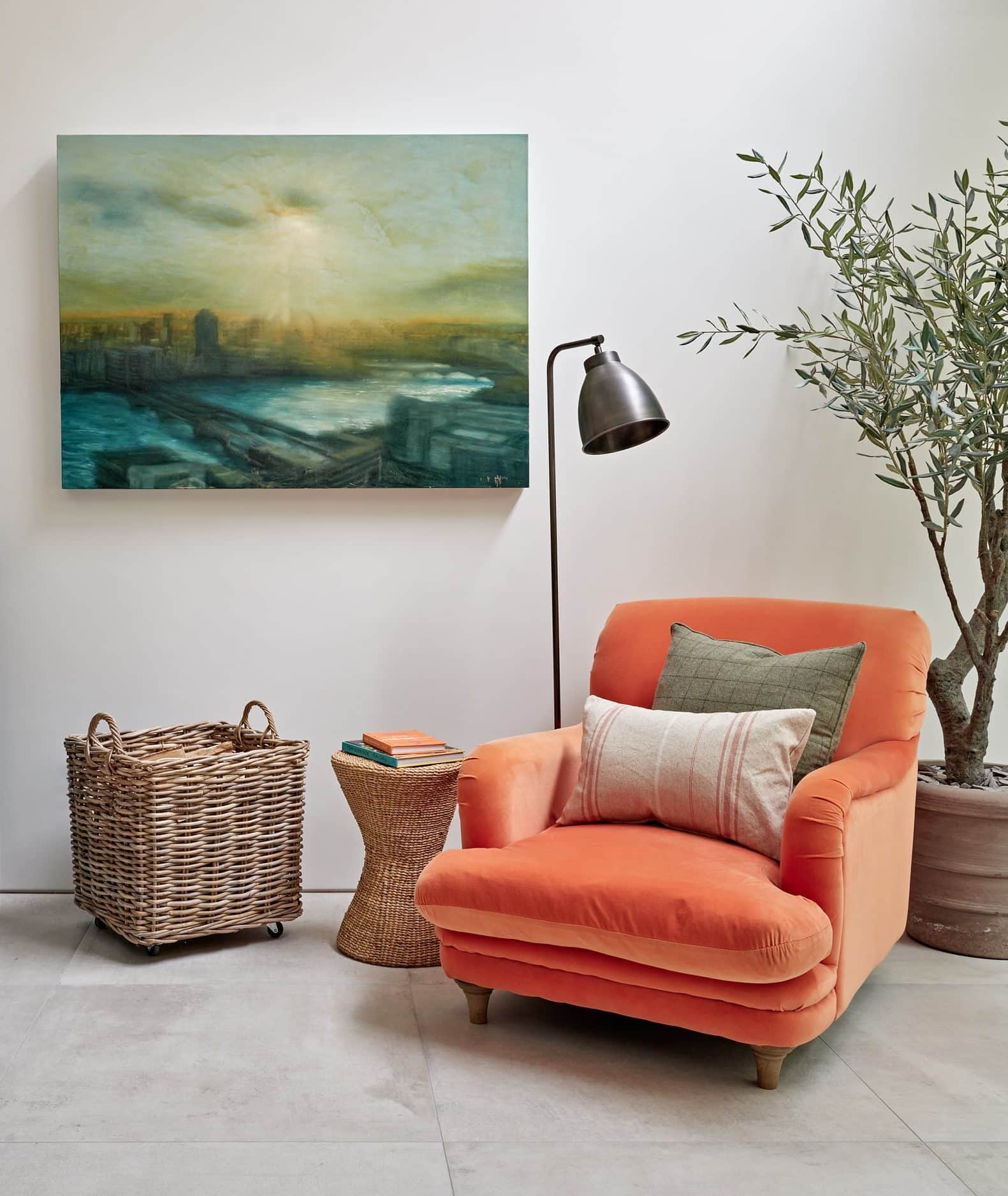 Reading space with a bright peach colour armchair.
