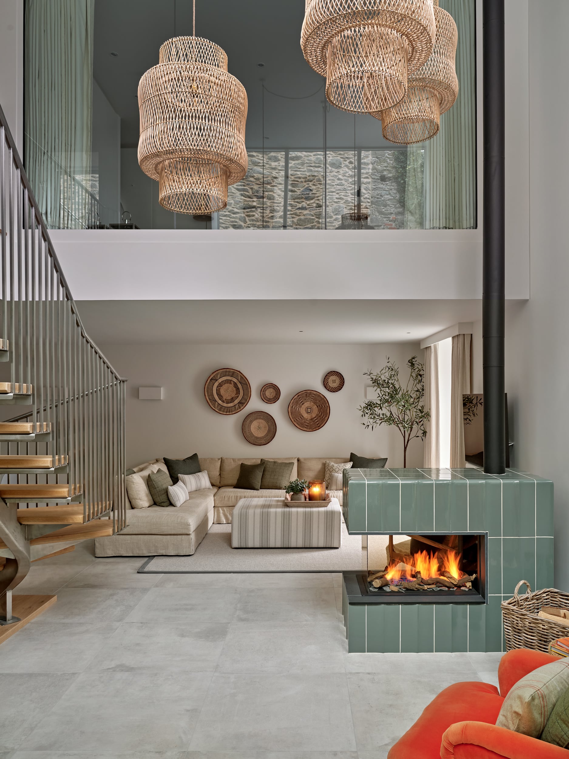 neutral coastal style living space with tiled fireplace in front.
