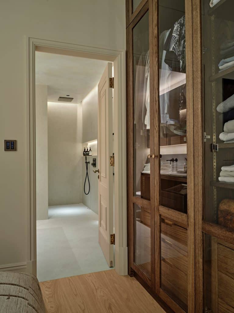 Entry to minimalist en-suite bathroom from bedroom.