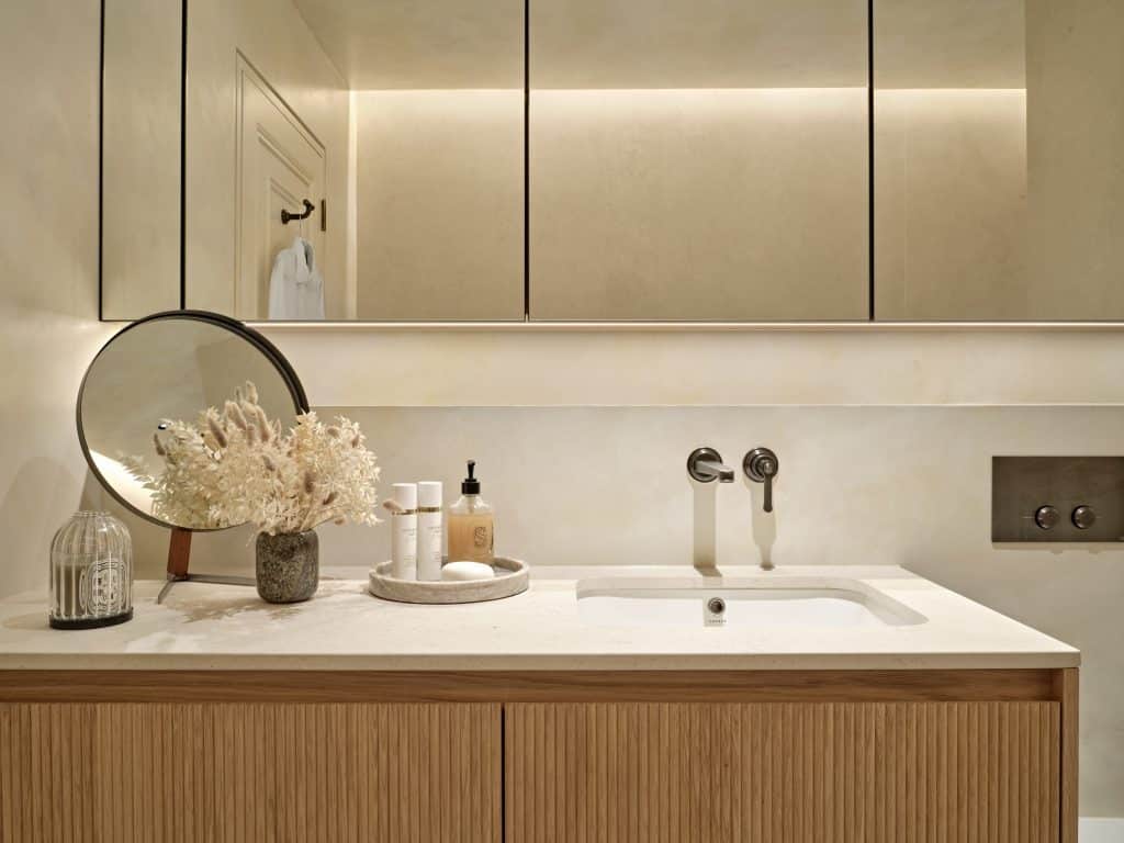 Countertop and cabinetry in neutral relaxing bathroom.